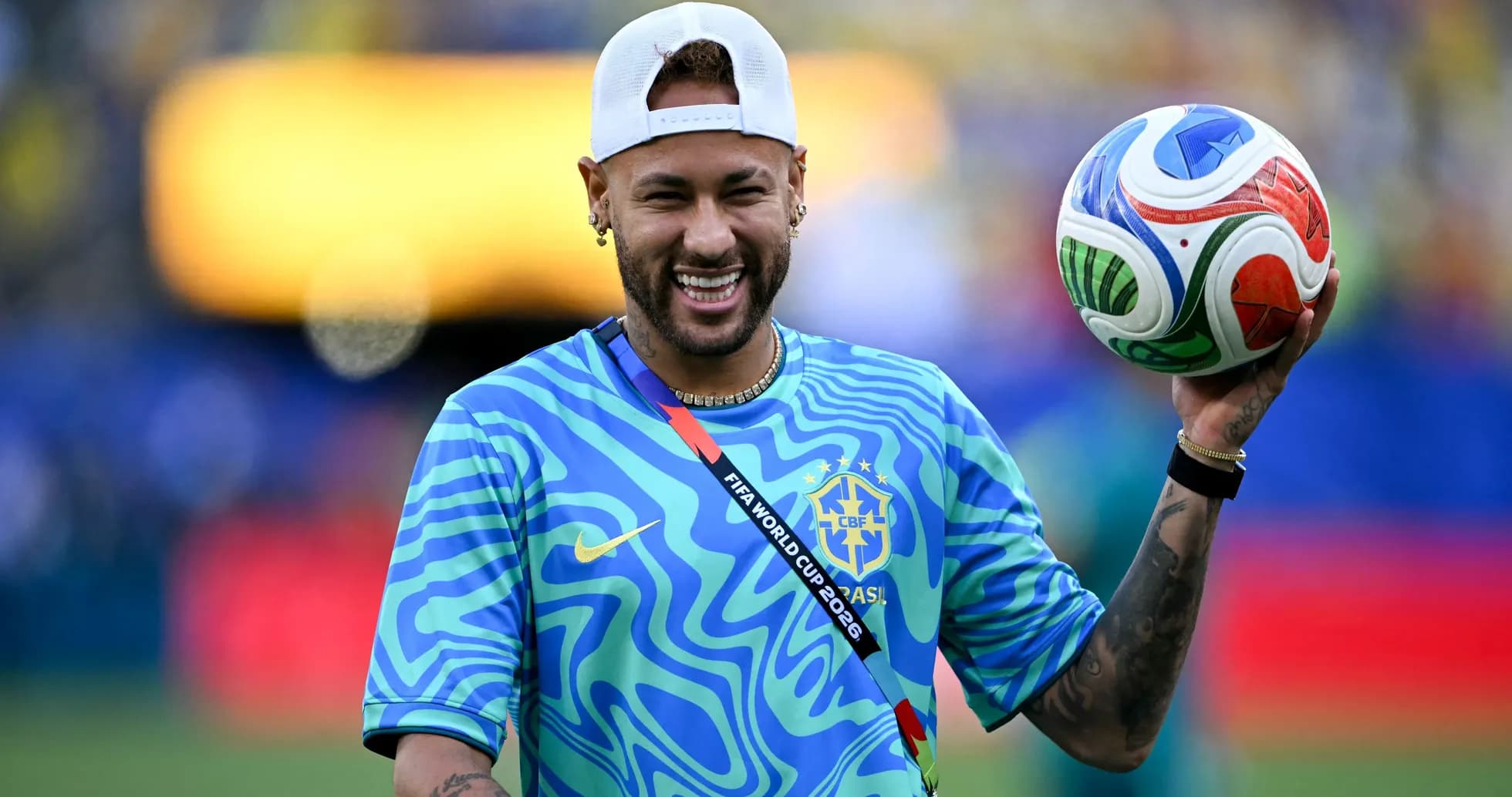 Player holding a soccer ball, wearing Brazil jersey