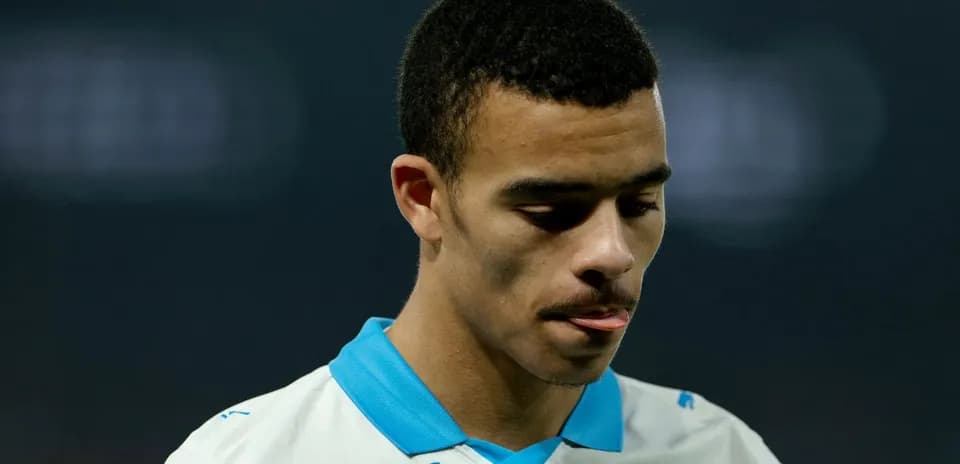 Player looking down during match, wearing team jersey