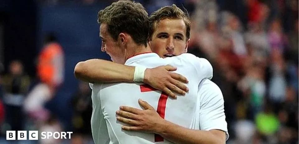 Two players embracing on the field after a goal
