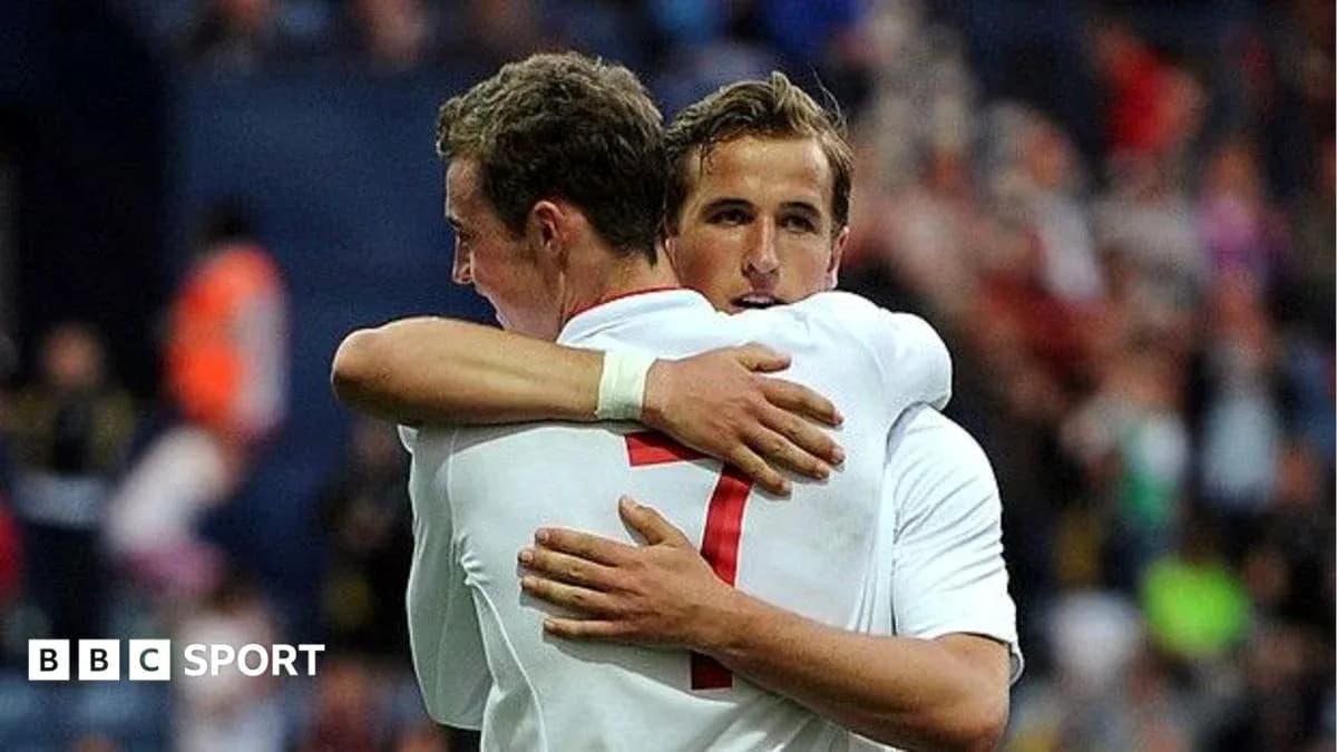 Two players embracing on the field after a goal