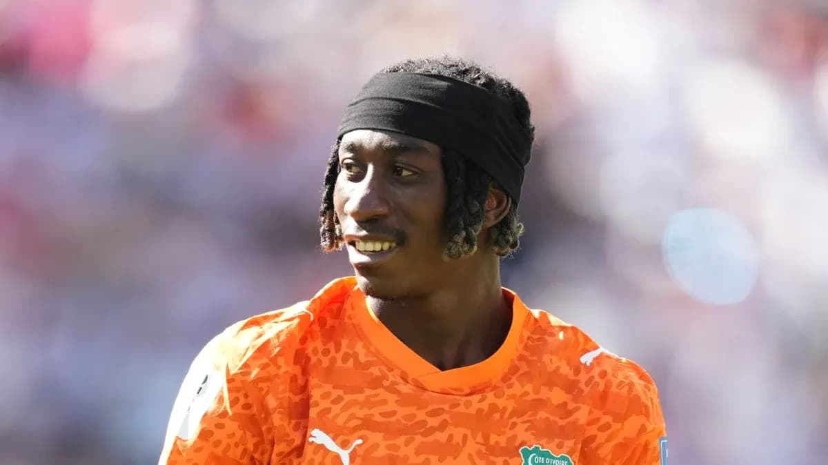 Goalkeeper in orange jersey during warm-up
