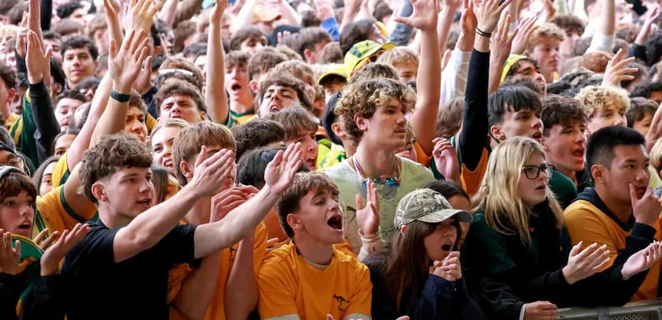 Crowd cheering enthusiastically at sports event