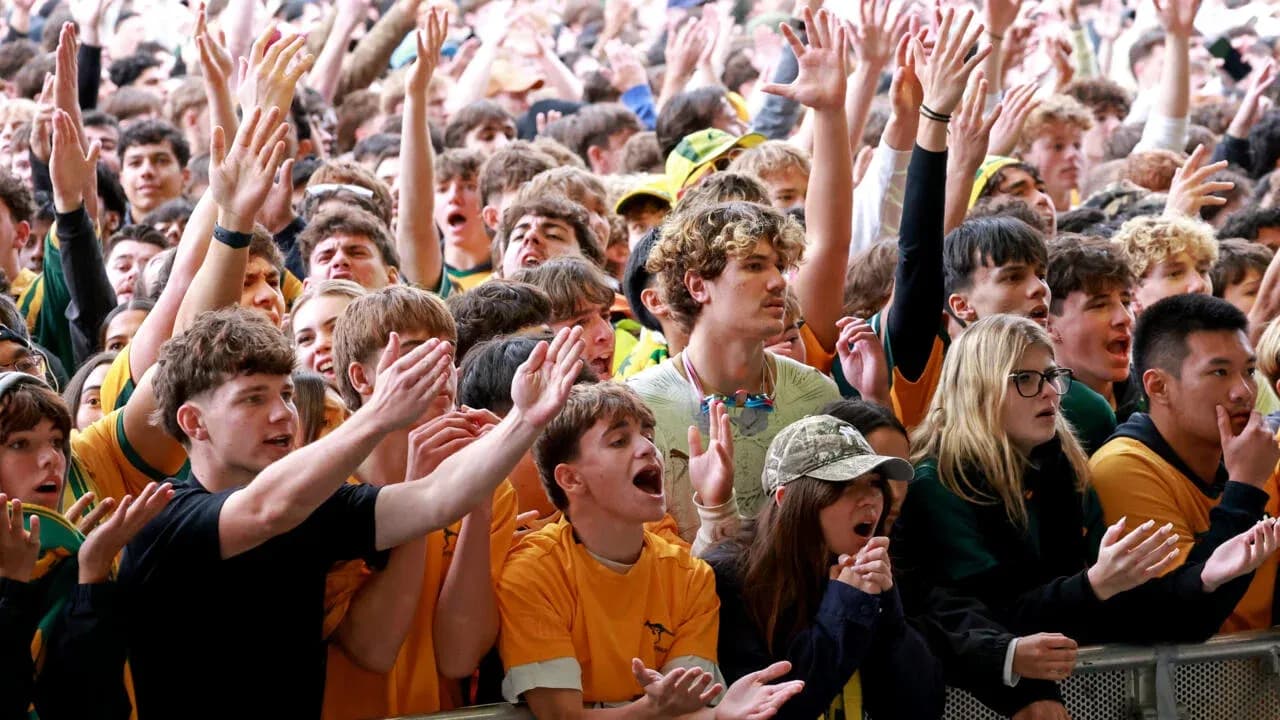 Crowd cheering enthusiastically at sports event