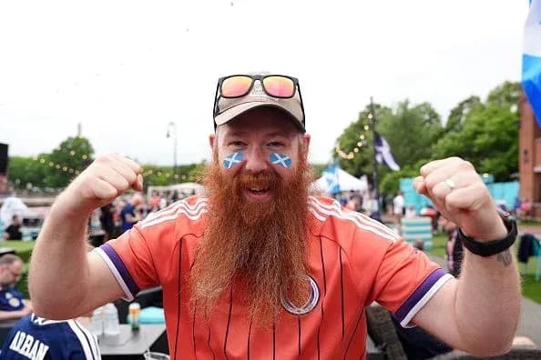 Fan celebrating with Scottish face paint and jersey