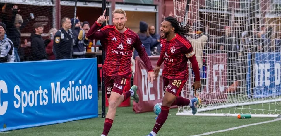 Players celebrating a goal during Detroit City match