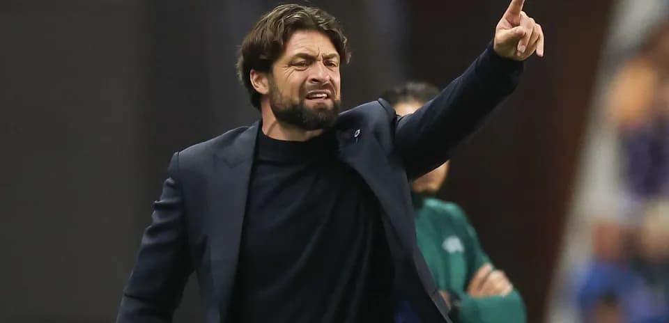 Coach directing players from the sidelines during match