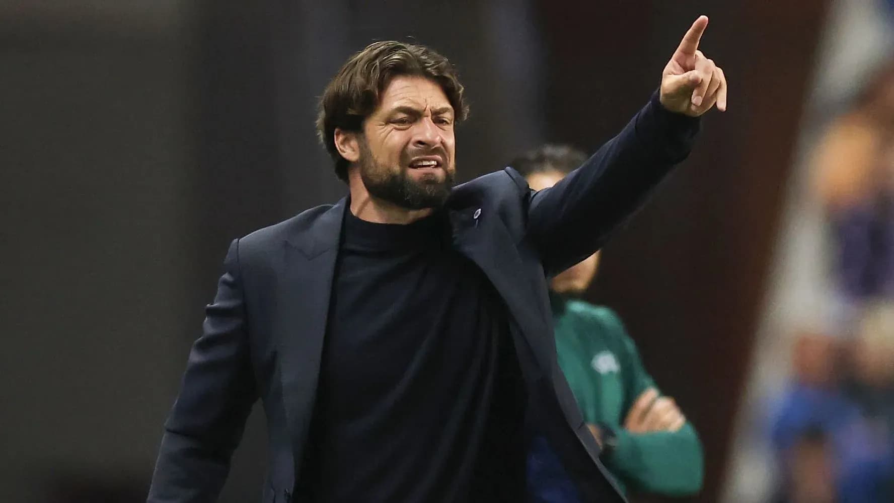 Coach directing players from the sidelines during match