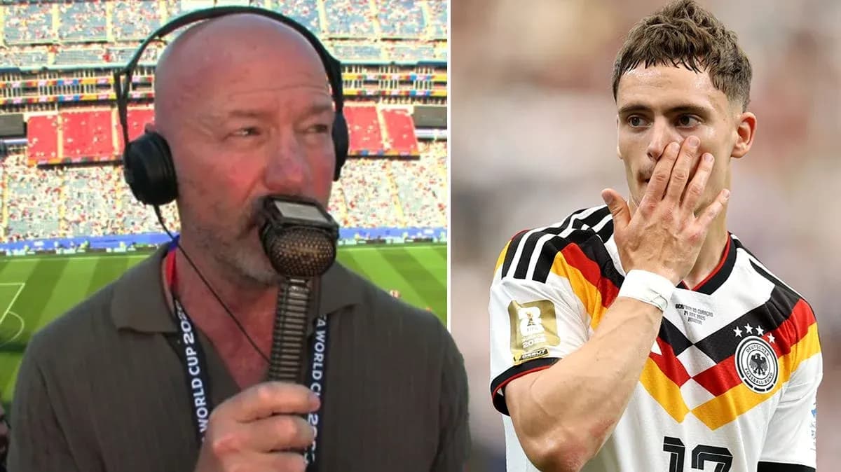 Commentator speaking into microphone at stadium