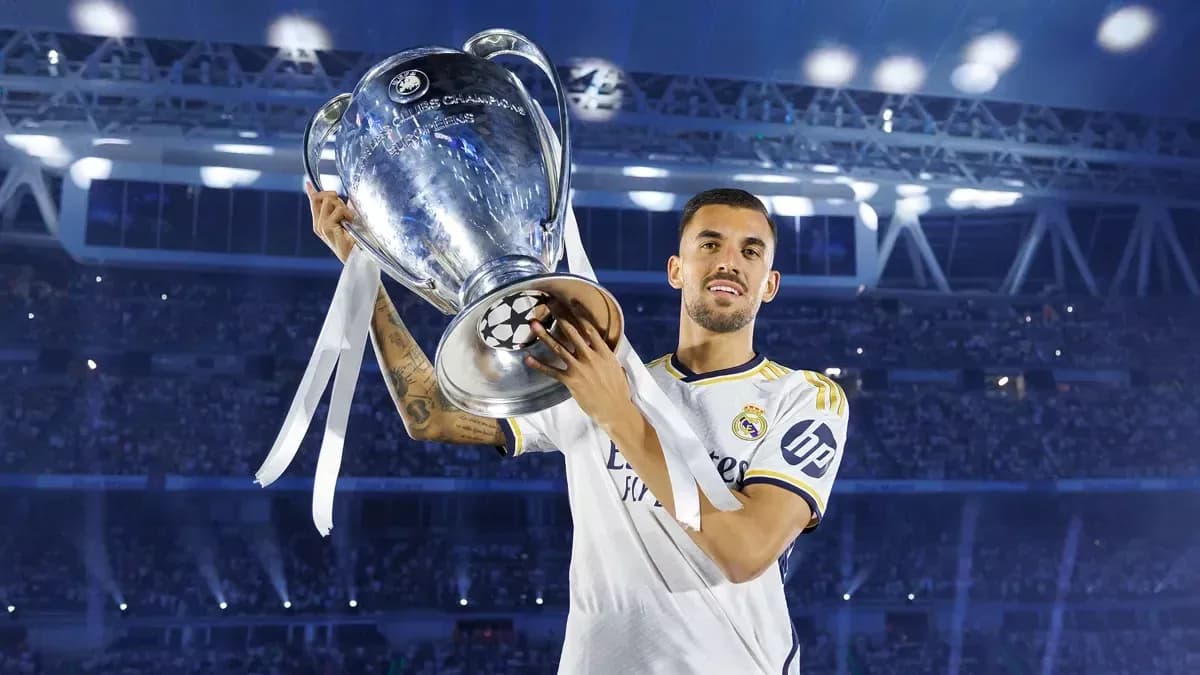 Player holding UEFA Champions League trophy in stadium