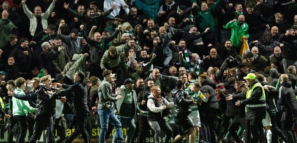 Fans celebrating on the pitch after a match