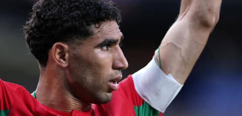Player celebrating with arm raised in team jersey