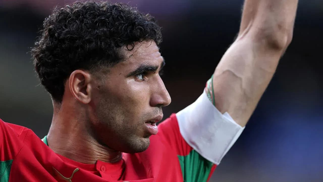 Player celebrating with arm raised in team jersey