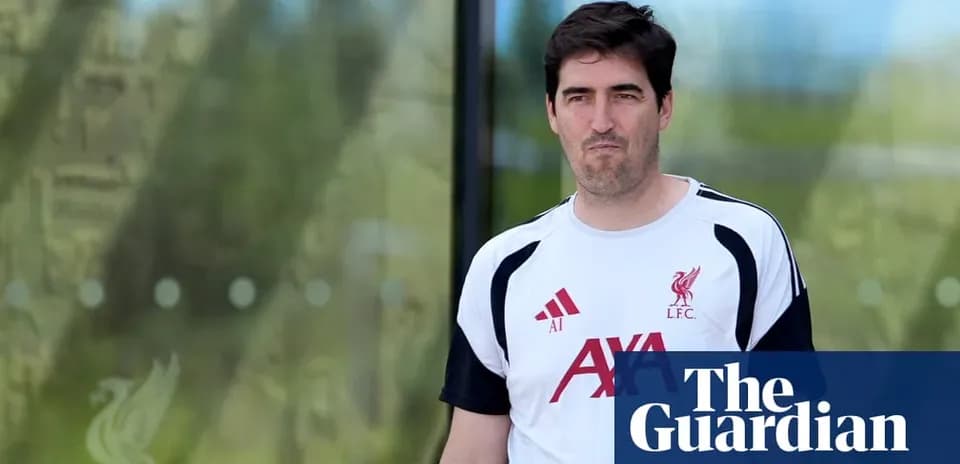 Man in Liverpool FC training kit walking outdoors