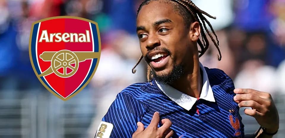 Player celebrating with Arsenal logo in background