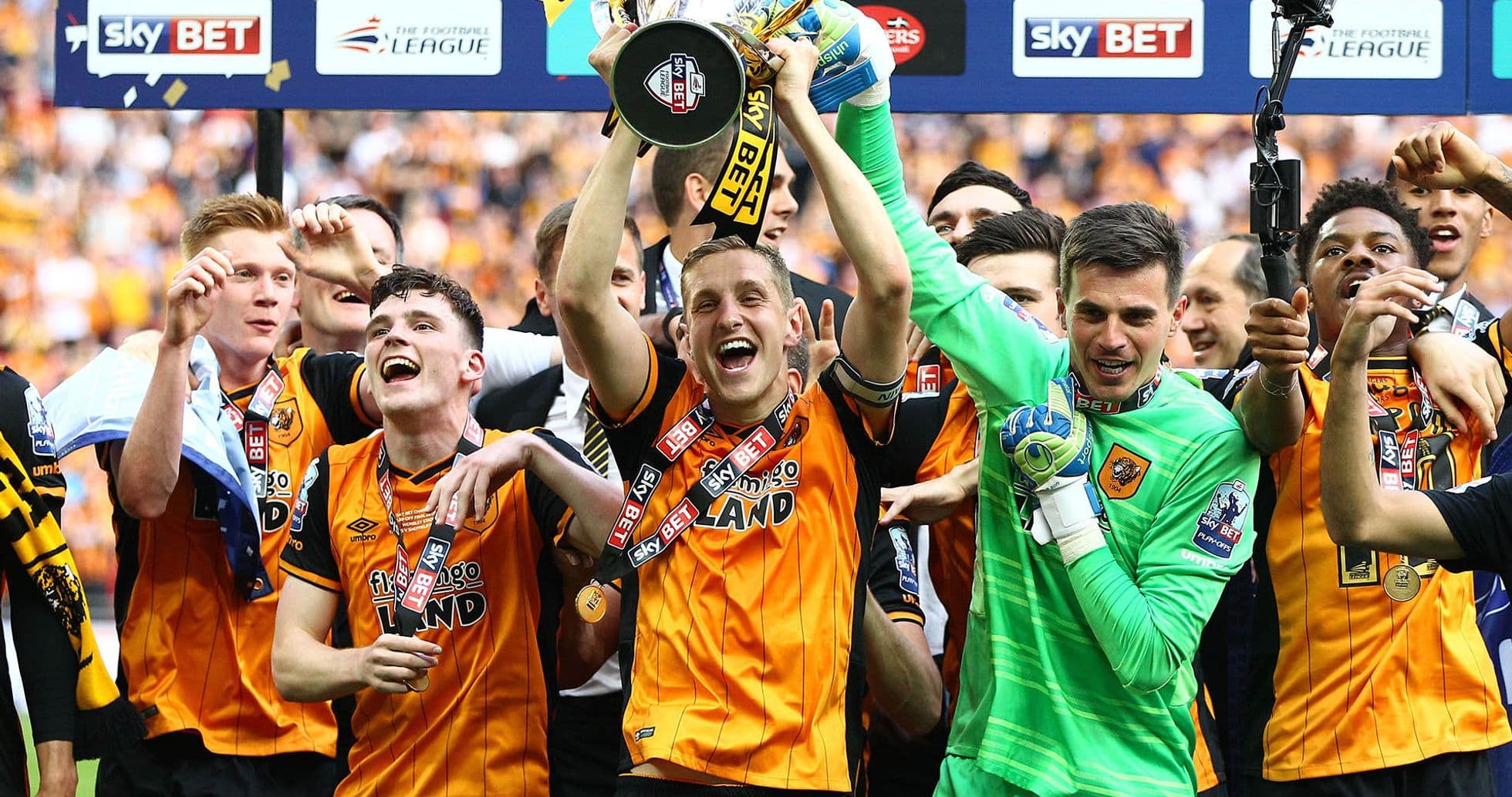 Players celebrating with trophy after winning championship