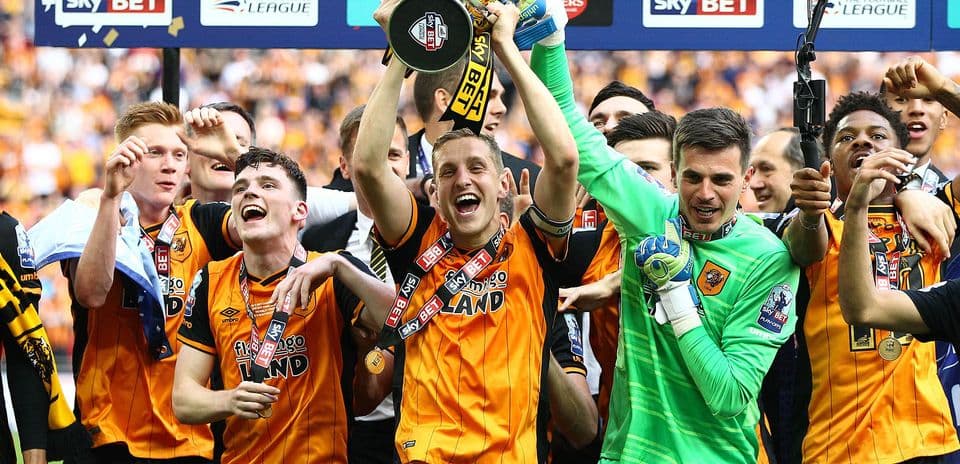 Players celebrating with trophy after winning championship