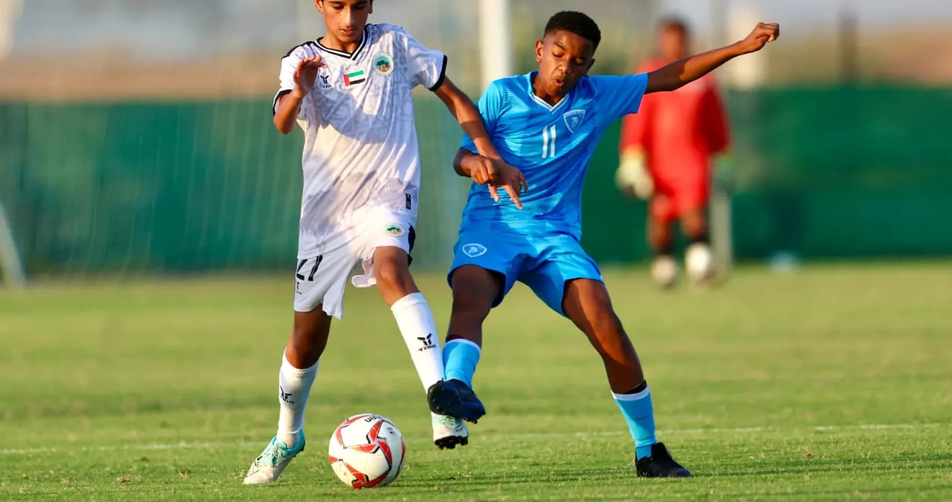 Al Sharjah U23 player challenging Al Bataeh U23 player
