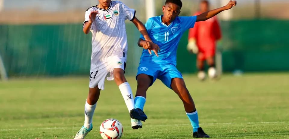 Al Sharjah U23 player challenging Al Bataeh U23 player