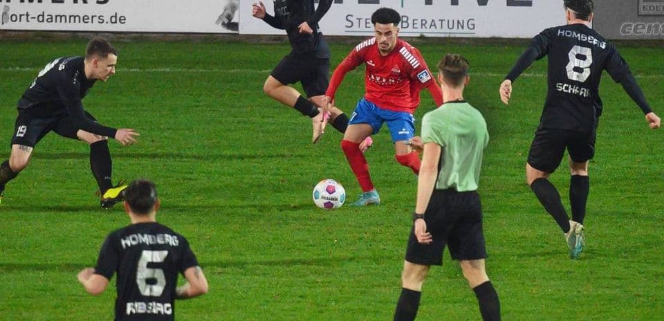 Players competing for the ball in football match