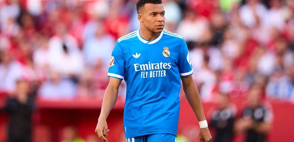 Player walking on pitch in blue Real Madrid kit