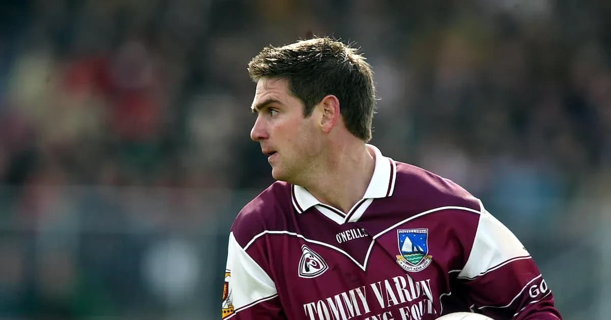 Player in maroon jersey running during a match