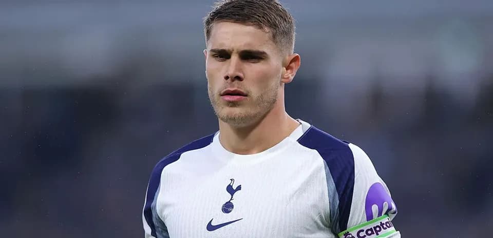 Player in Tottenham kit with captain armband