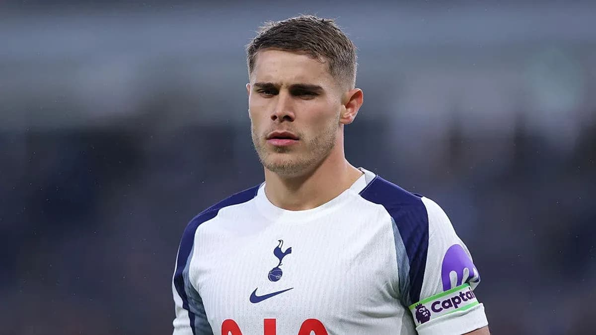 Player in Tottenham kit with captain armband