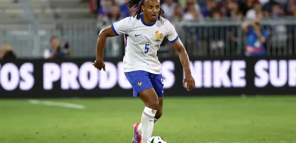 Player in France kit dribbling the ball on field