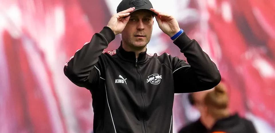 Coach adjusting cap during a match on the sidelines