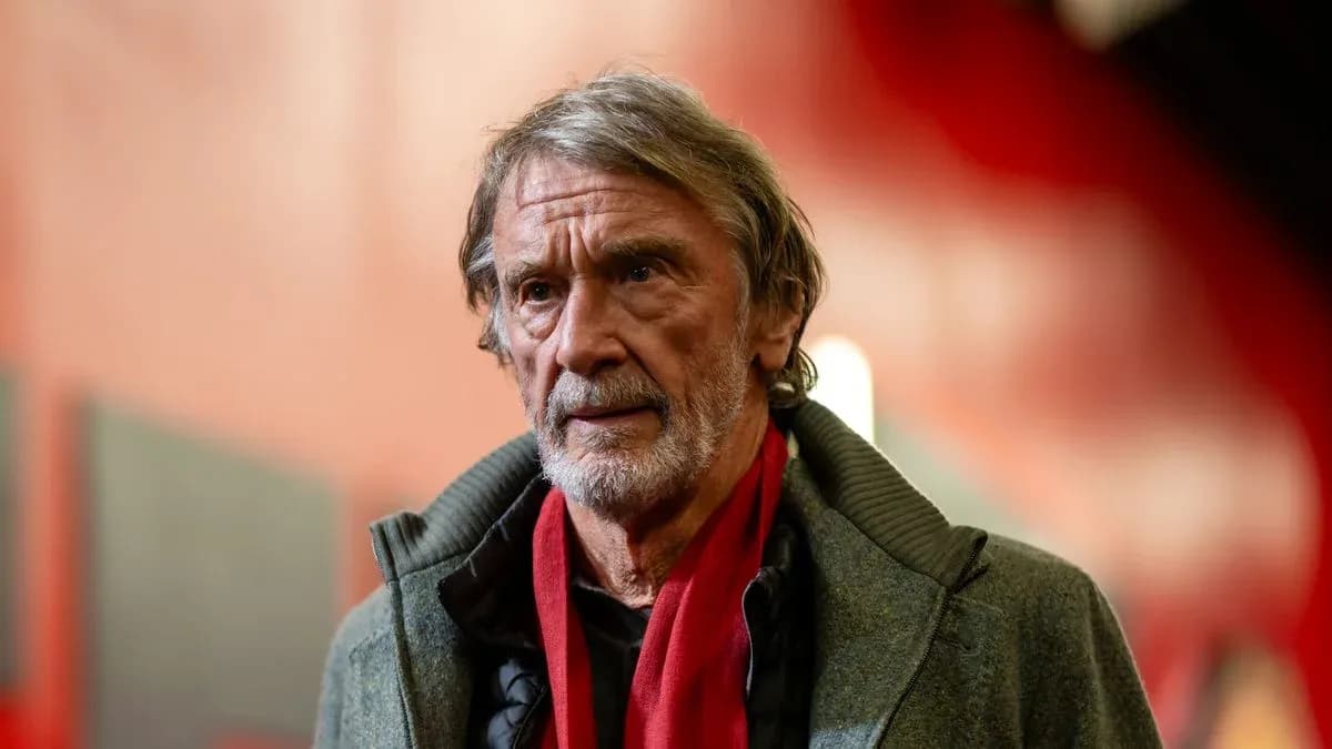 Man with gray hair wearing a scarf indoors