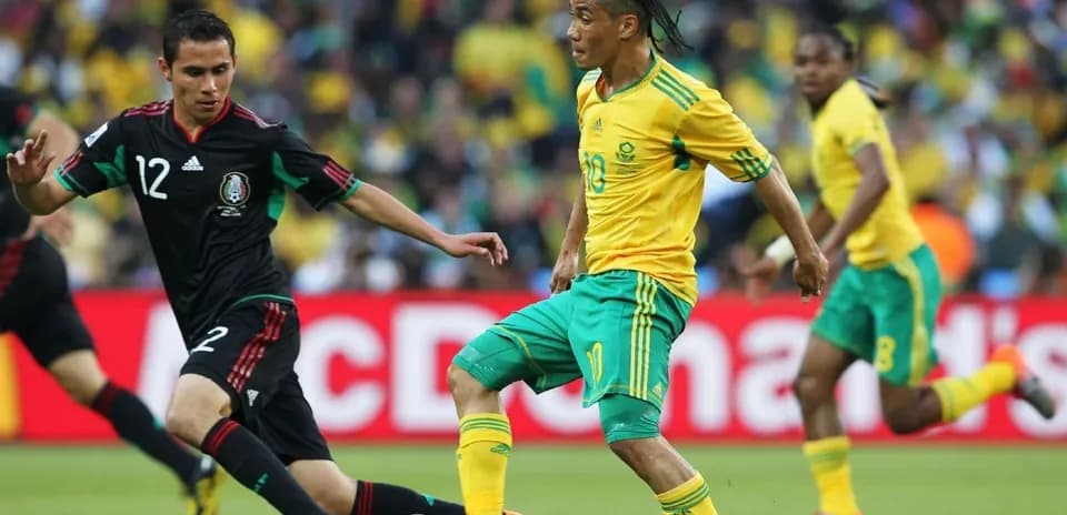 Player dribbling the ball during match between teams