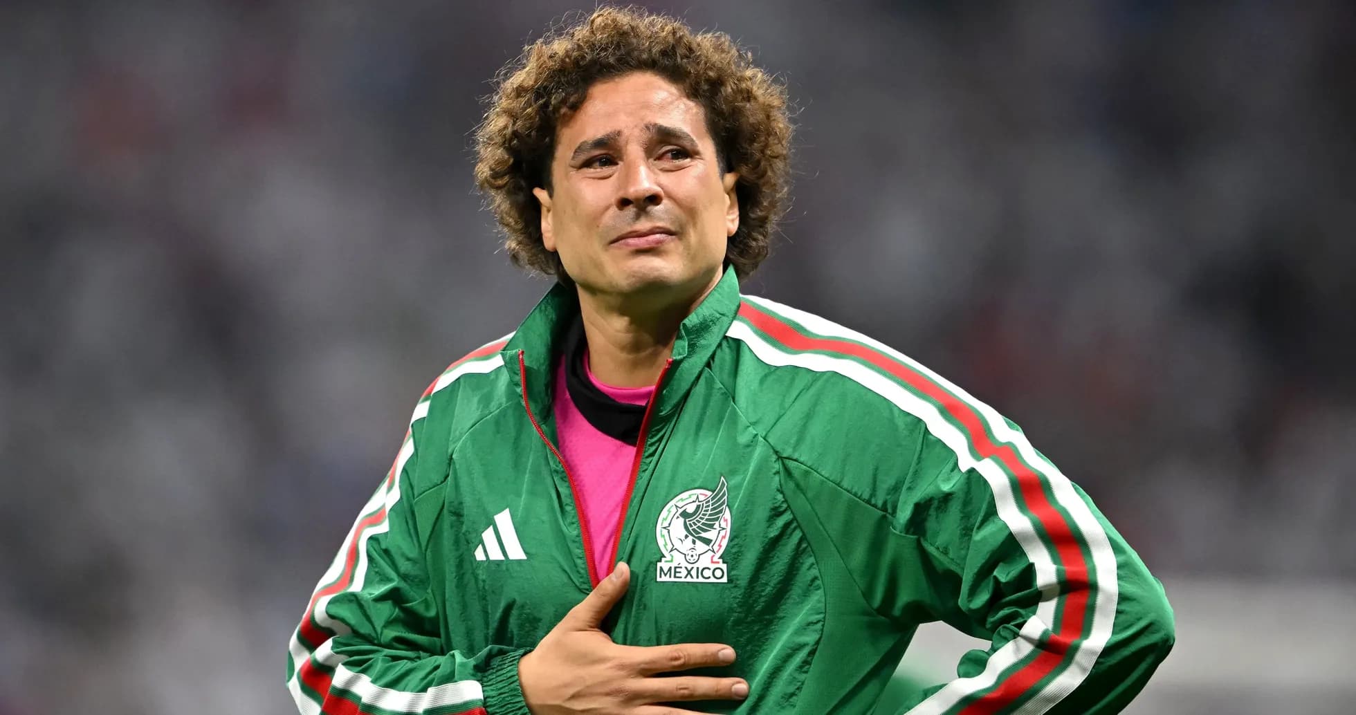 Goalkeeper in green jacket during match reflection