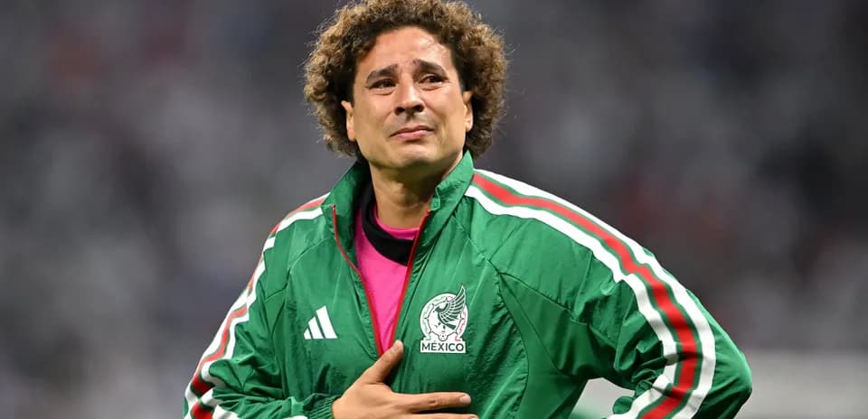 Goalkeeper in green jacket during match reflection