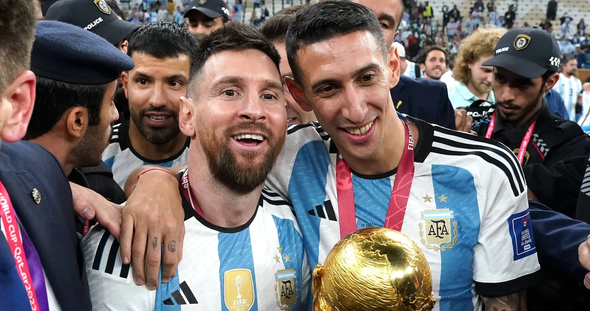 Messi and Di María celebrating with World Cup trophy