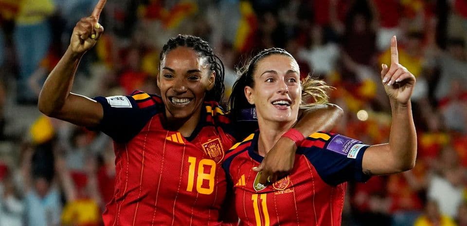 Two Spanish players celebrating a goal during match