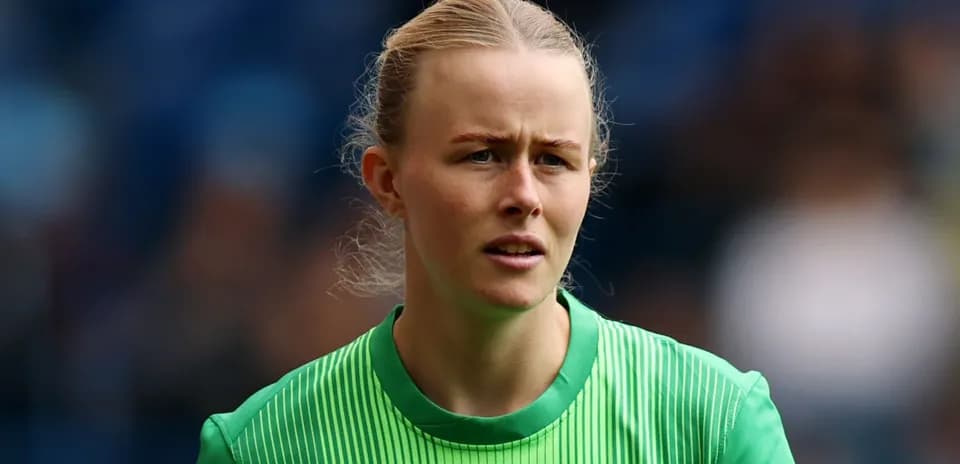 Goalkeeper wearing green kit during match preparation