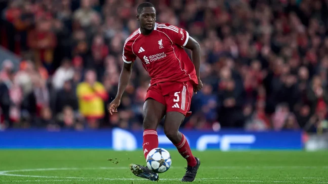 Player in Liverpool kit dribbling ball on pitch