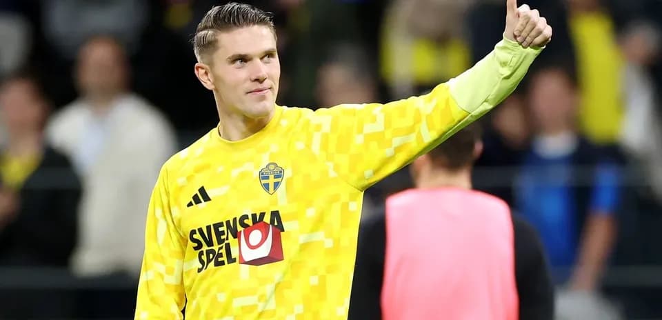 Goalkeeper wearing yellow kit giving thumbs up