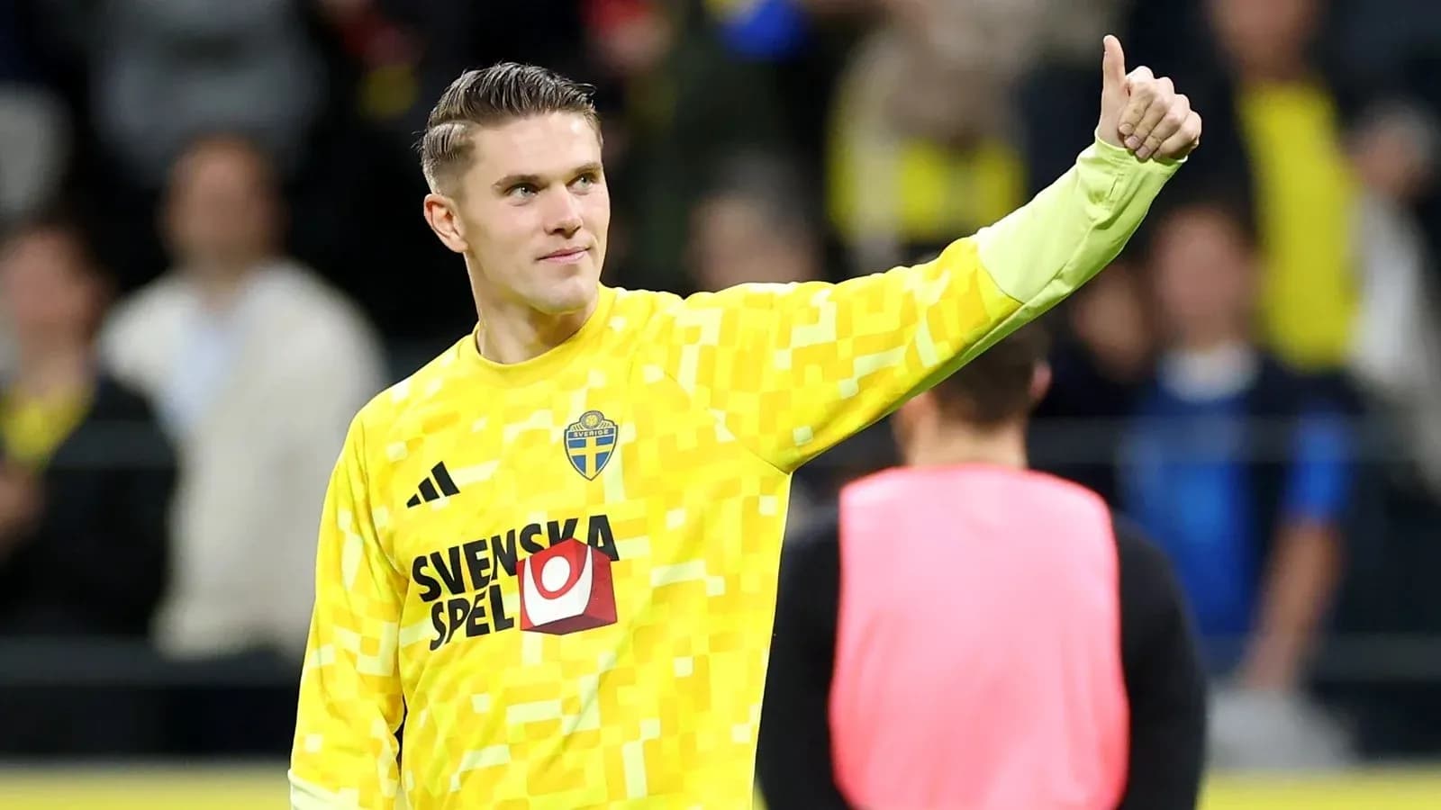 Goalkeeper wearing yellow kit giving thumbs up