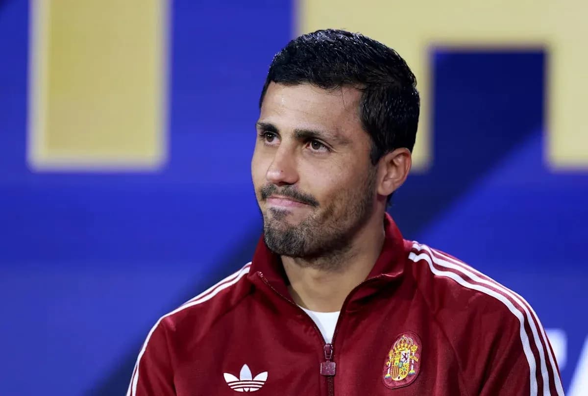 Football player in red training jacket at press conference