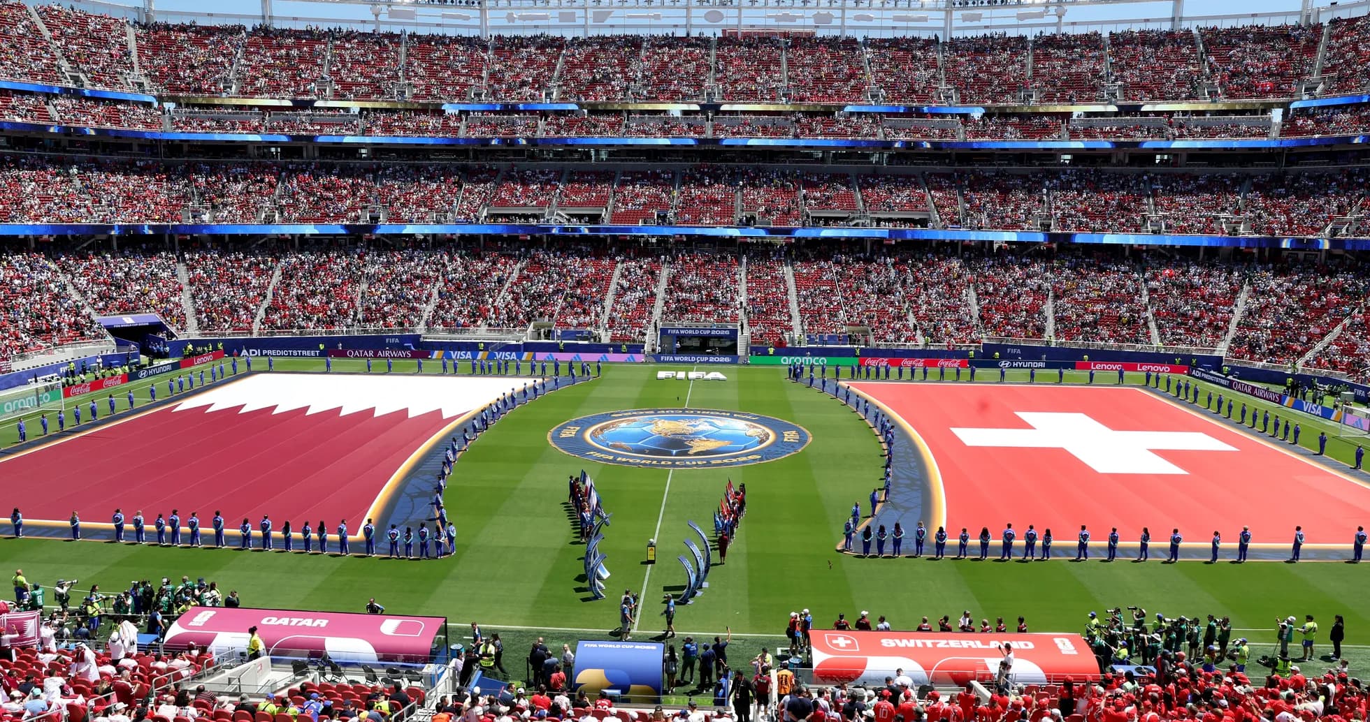 Qatar and Switzerland flags on the field