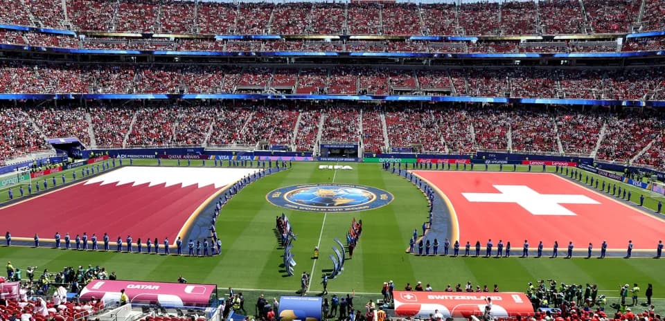 Qatar and Switzerland flags on the field