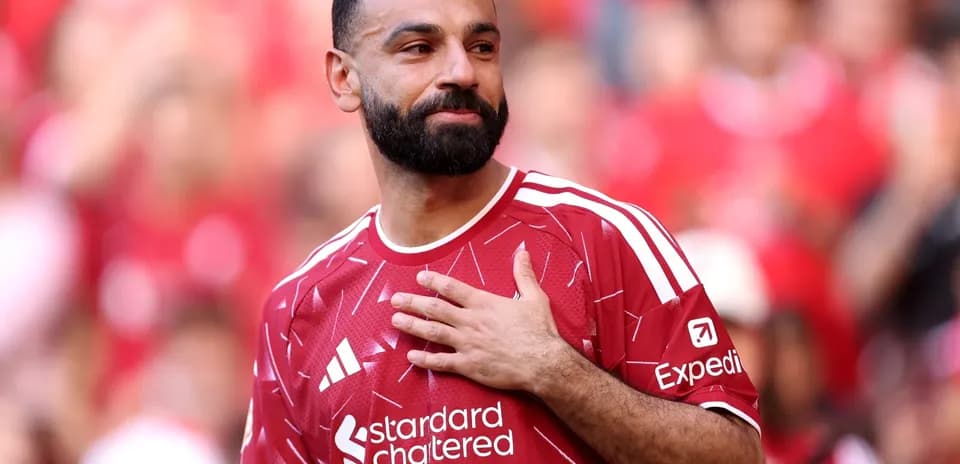 Player in red jersey acknowledging the crowd