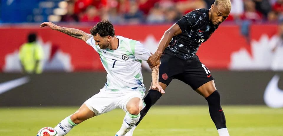 Two players contesting for the ball on the field