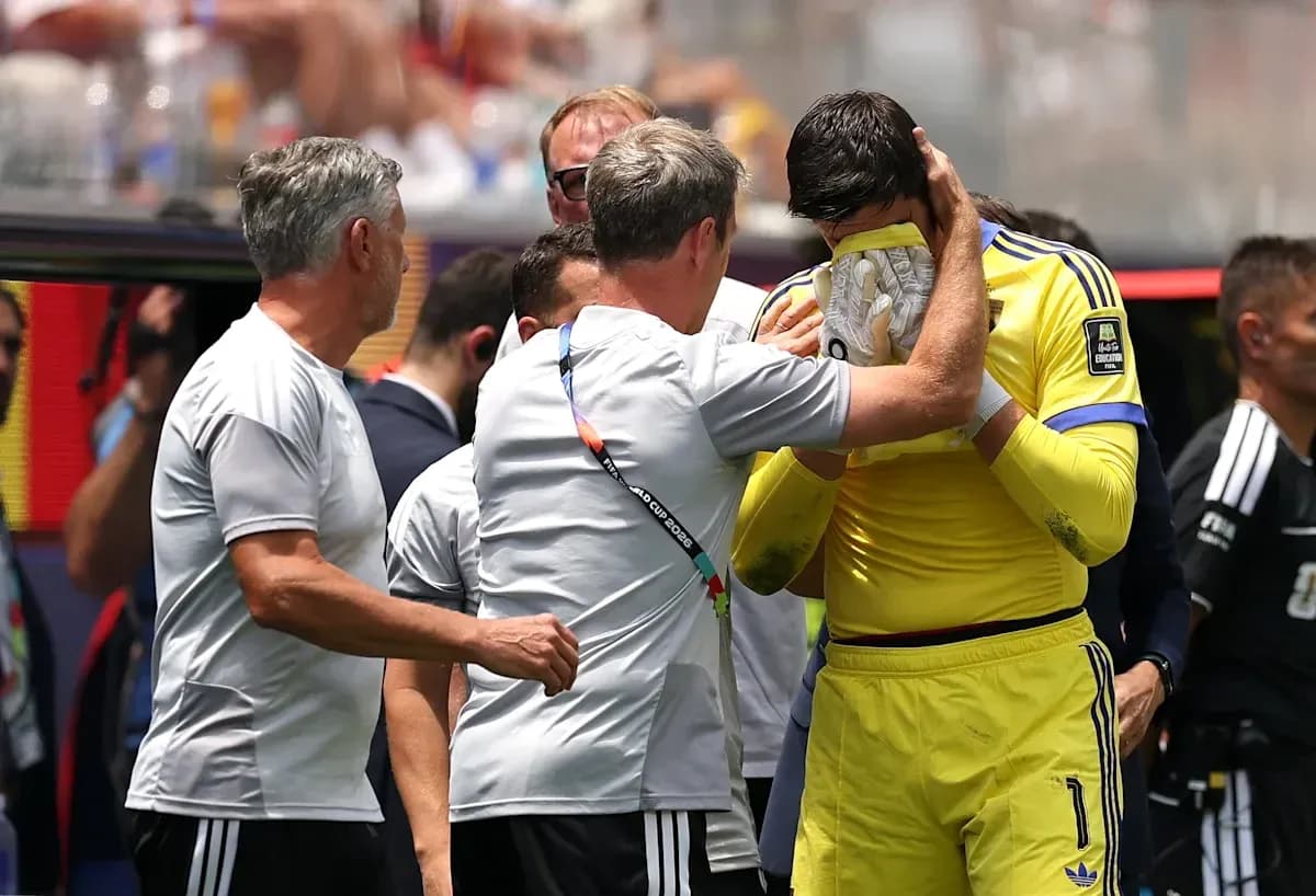 Coach comforting goalkeeper after match on sidelines
