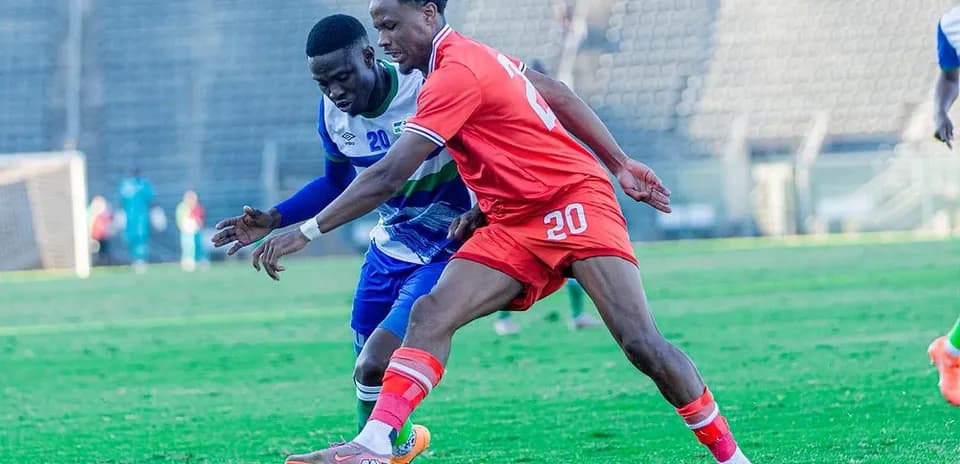 Two players contesting for the ball on the field
