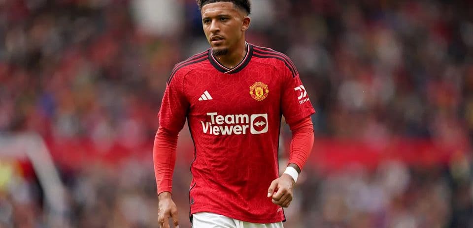 Player in Manchester United jersey on the pitch
