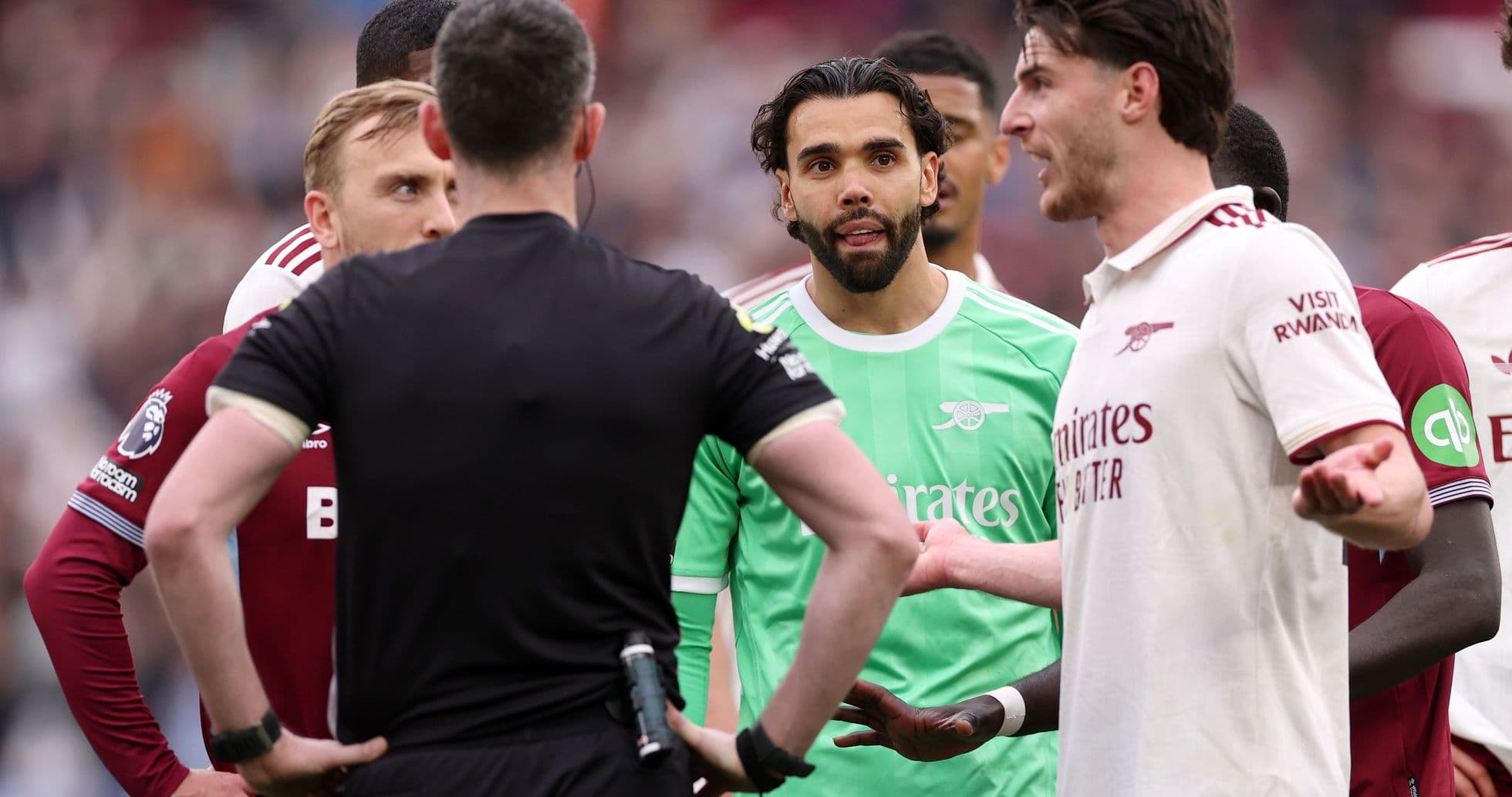 Players and referee discussing during match confrontation