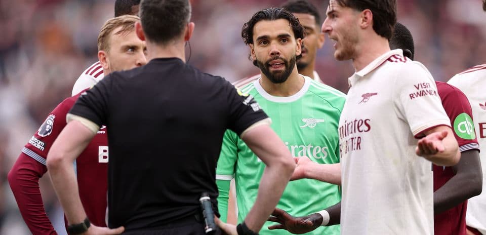 Players and referee discussing during match confrontation