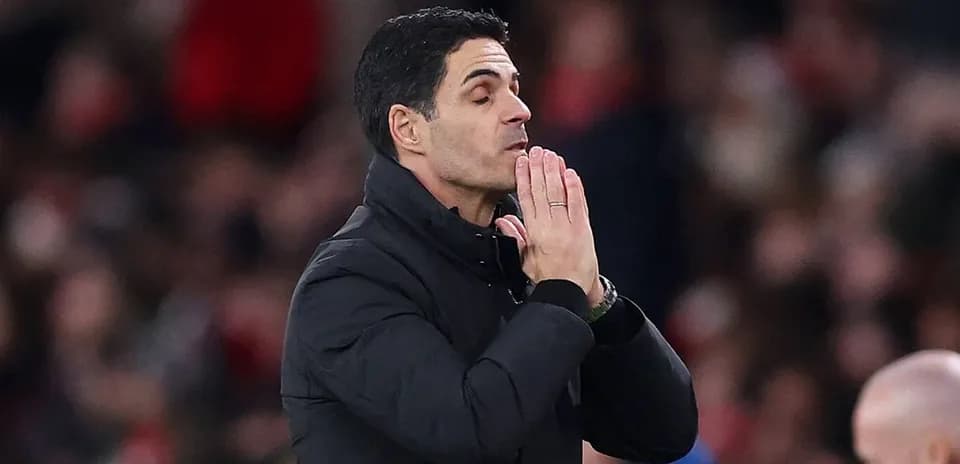 Manager gesturing during a match on the sidelines